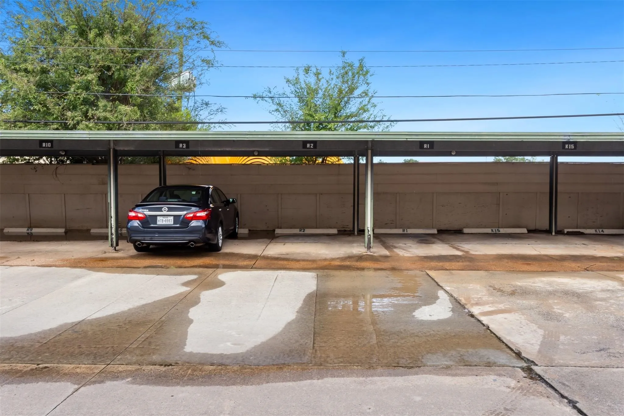 Covered parking structure with multiple designated spaces and a concrete surface