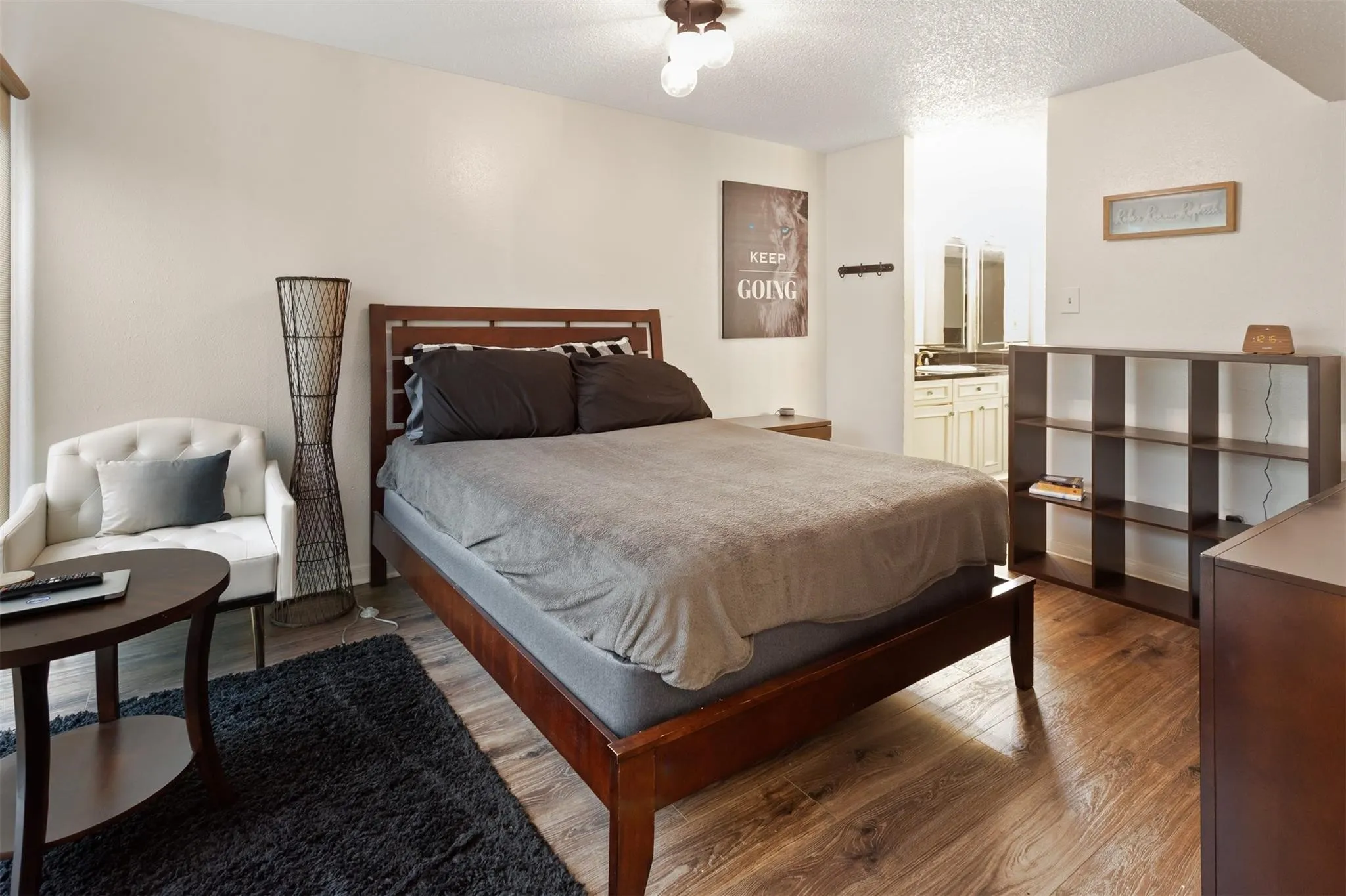 Bedroom 1 - Wood-finish flooring throughout, light-toned walls, and a built-in ceiling light fixture