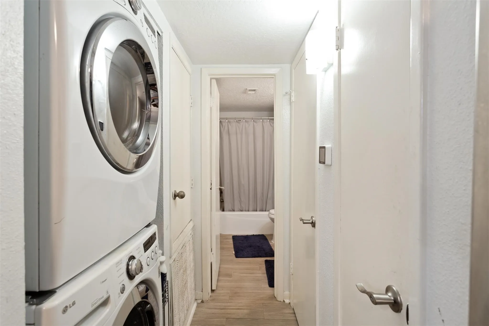 Bathroom 2 - Stackable white laundry appliances