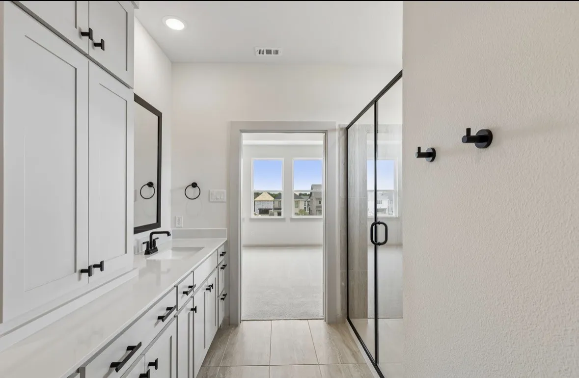Extended vanity with ample storage, a single sink, and a framed mirror