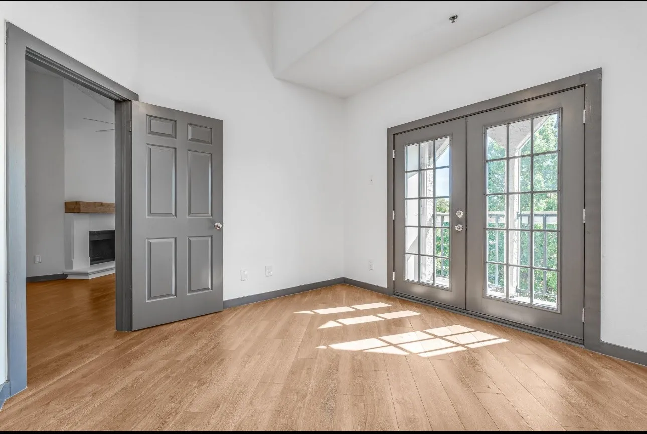 Entryway with light wood-type flooring and french doors
