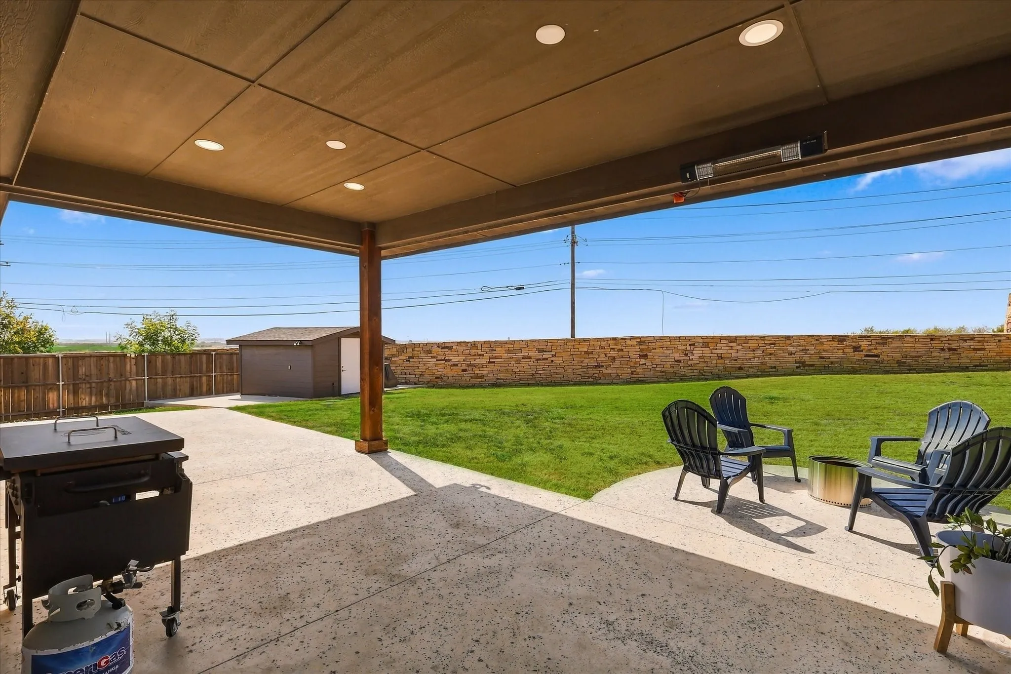 Covered patio with recessed lighting, integrated overhead heater, and concrete flooring