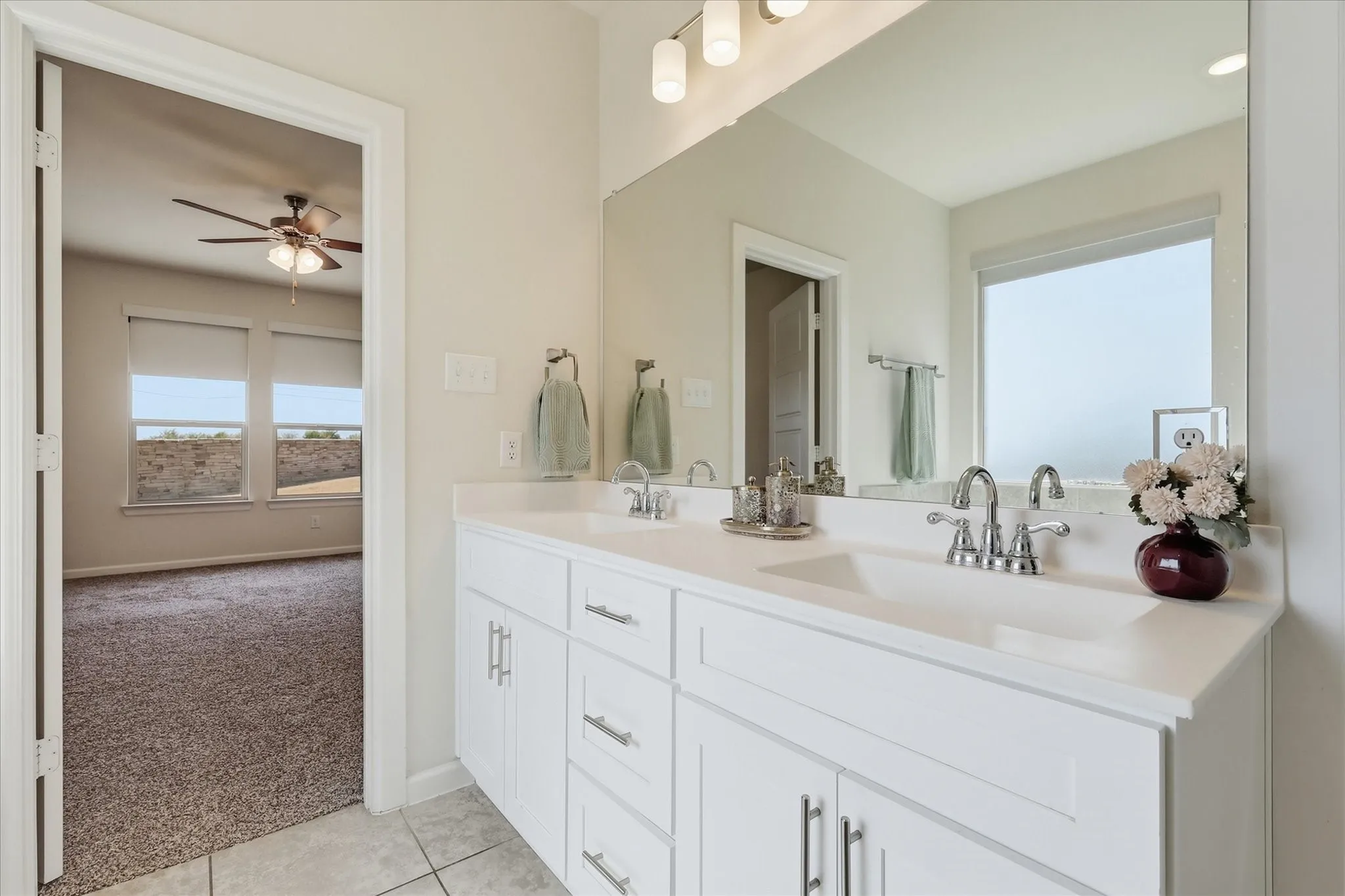 Dual vanity with white cabinetry and integrated sinks