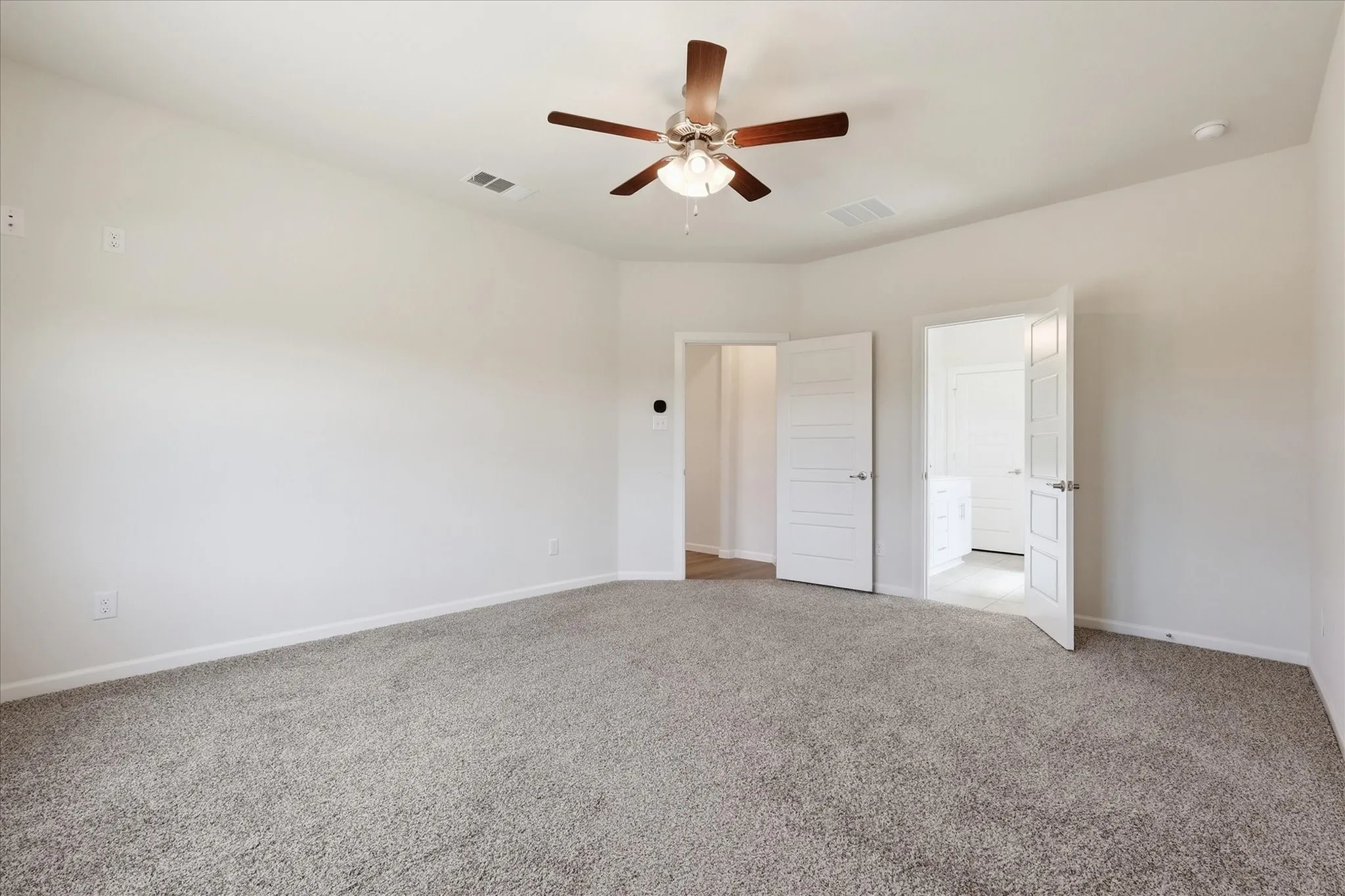 Neutral tone wall paint, light gray carpet, recessed lighting, and a ceiling fan with light fixture