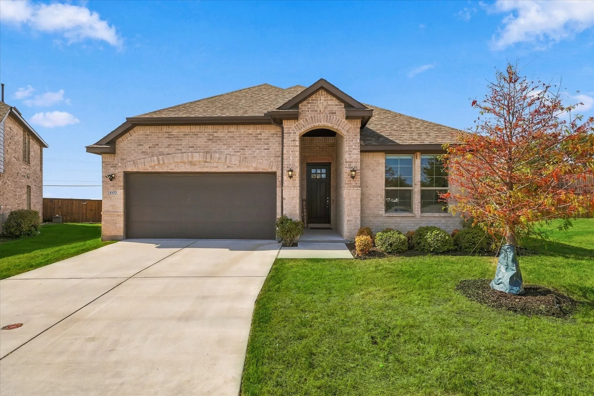 Brick exterior with an arched entryway and covered porch