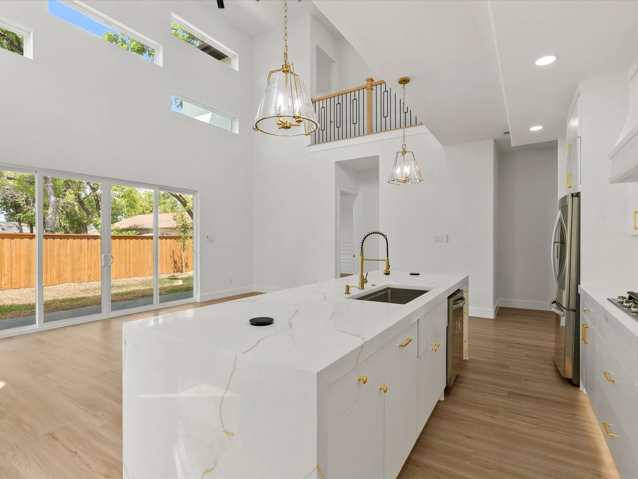 water fall island, quartz countertops, stainless steel appliances