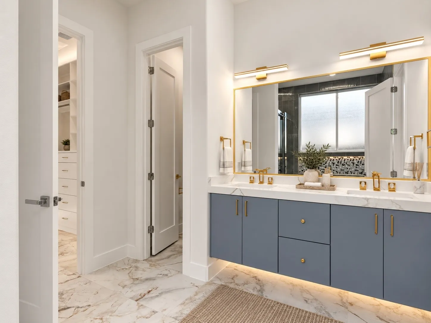 Floating cabinetry, undermount sinks, lighting underneath cabinetry, and gold-finish fixtures.
