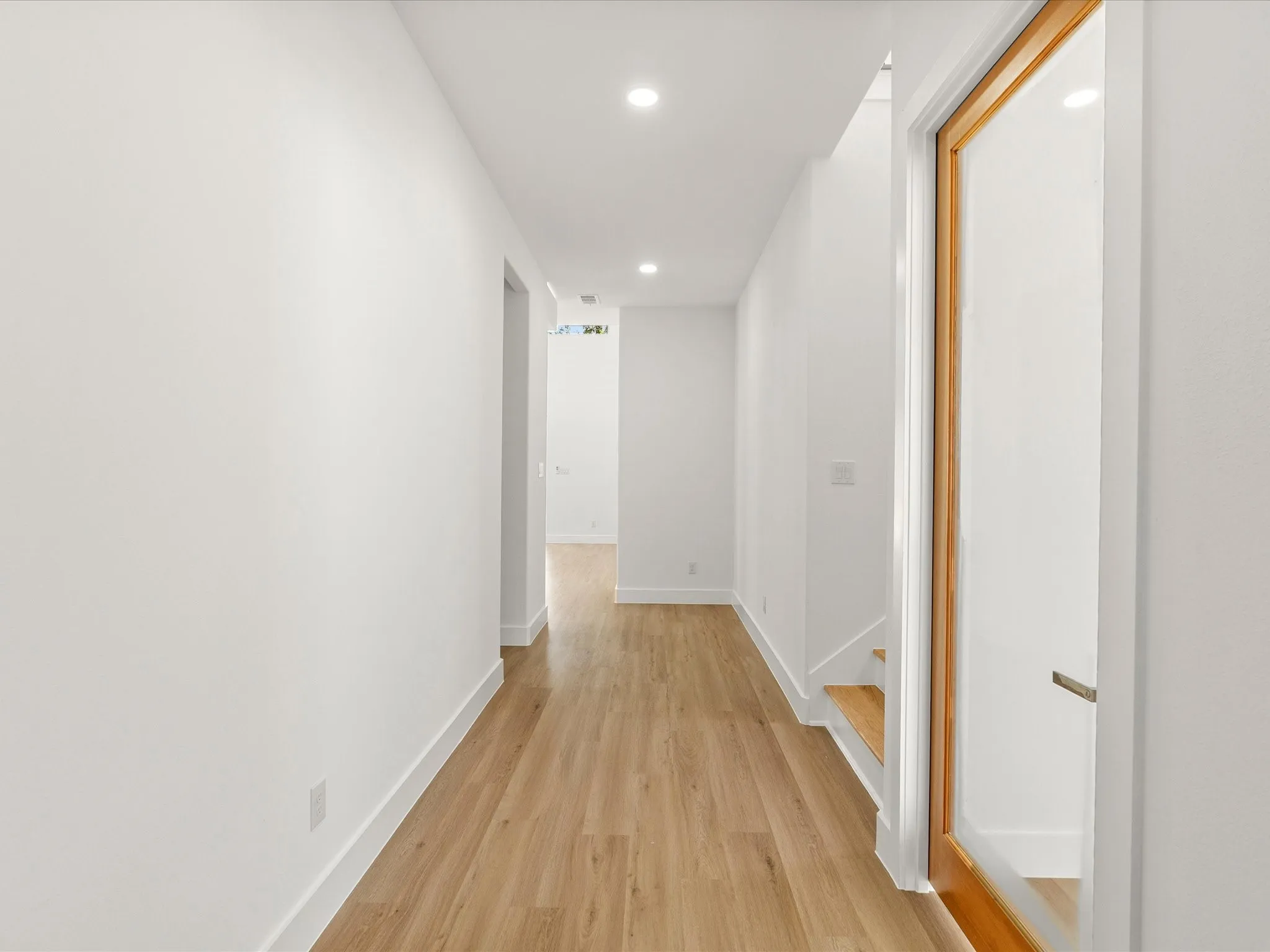 Recessed ceiling lighting, luxury vinyl flooring.