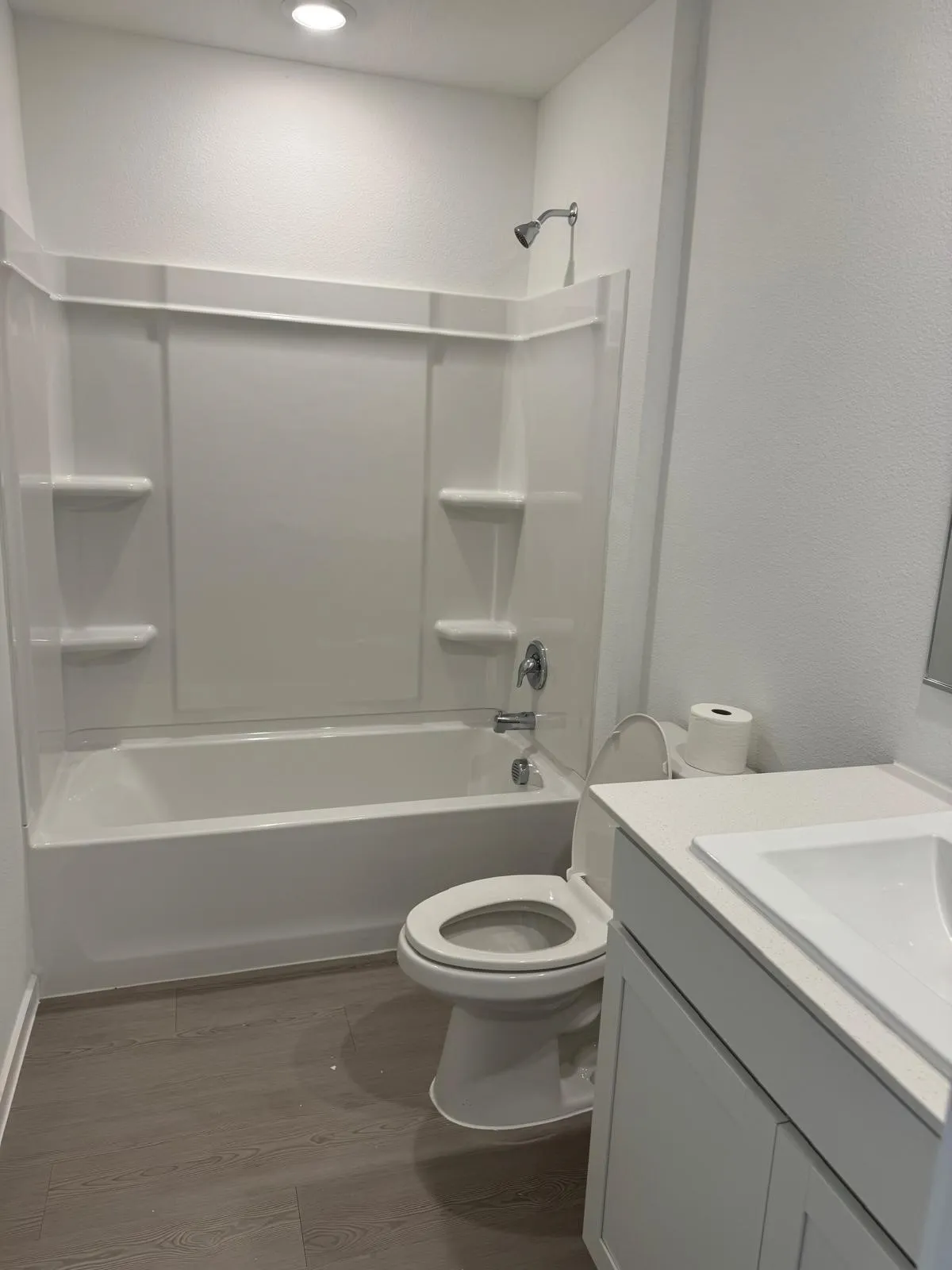 Full bathroom featuring vanity, shower / washtub combination, dark wood finished floors, and a textured wall