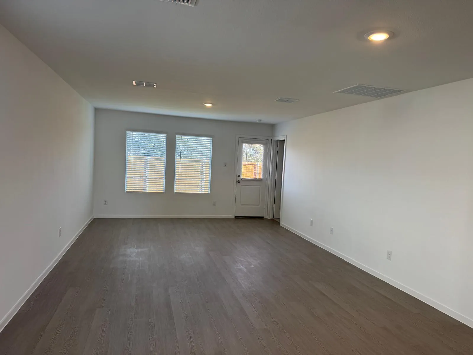 Spare room featuring dark wood-style flooring and recessed lighting