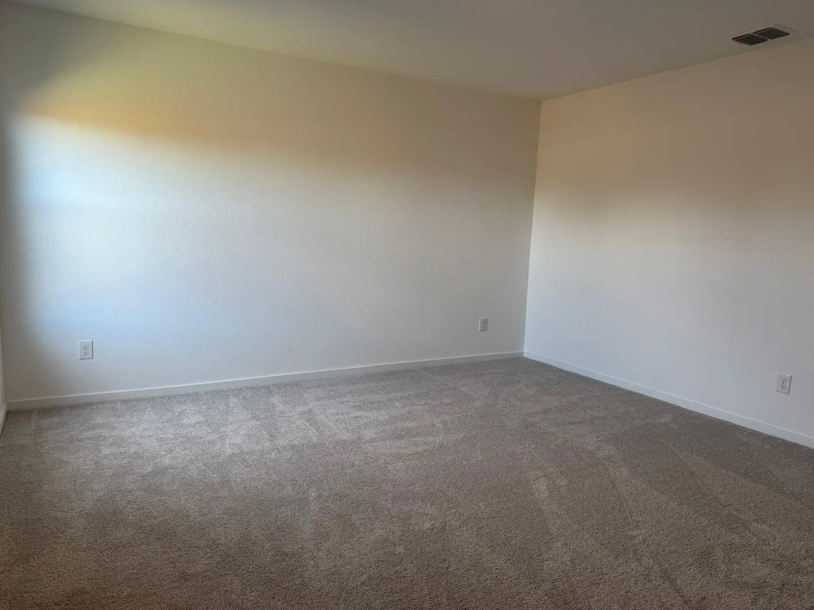 Spare room with carpet floors and baseboards