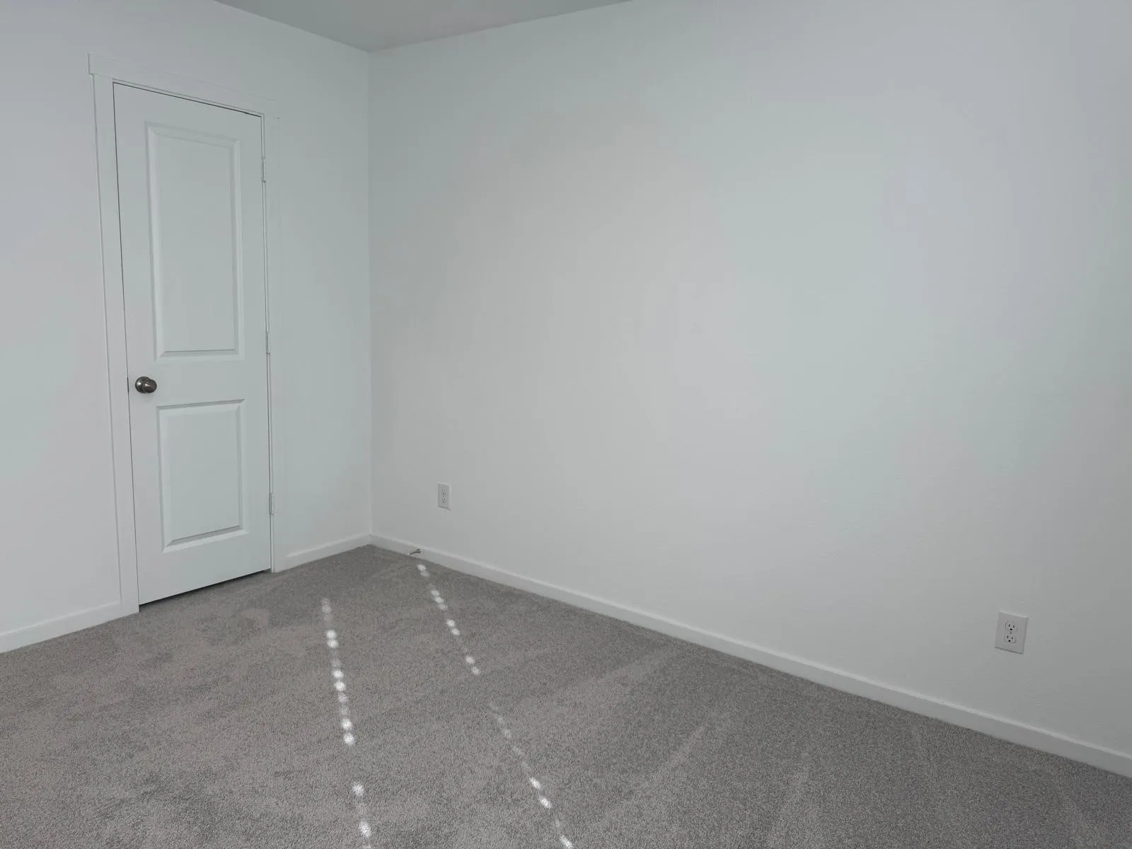 Unfurnished room featuring carpet floors and baseboards