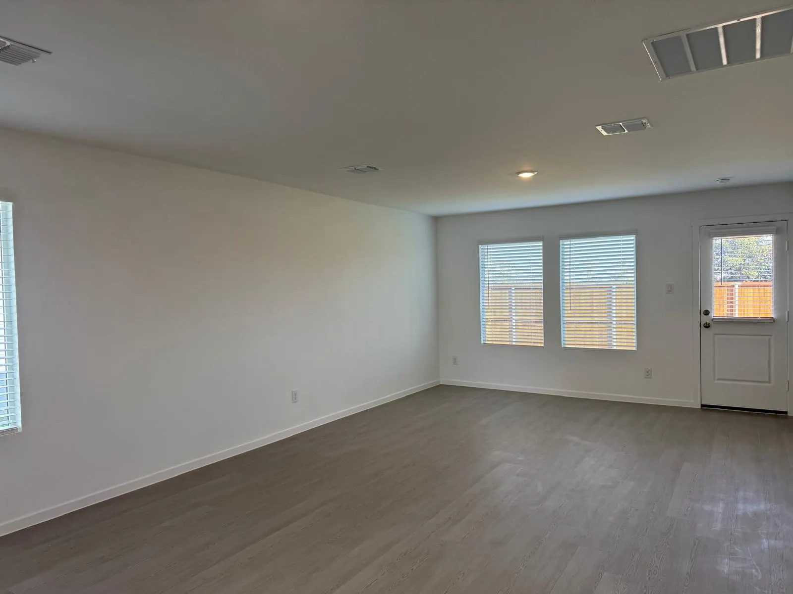 Empty room featuring wood finished floors and baseboards