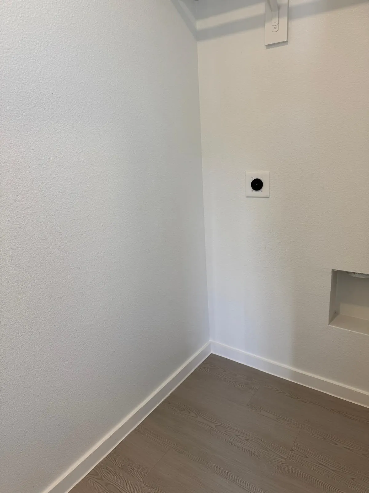 Laundry area featuring electric dryer hookup and dark wood finished floors