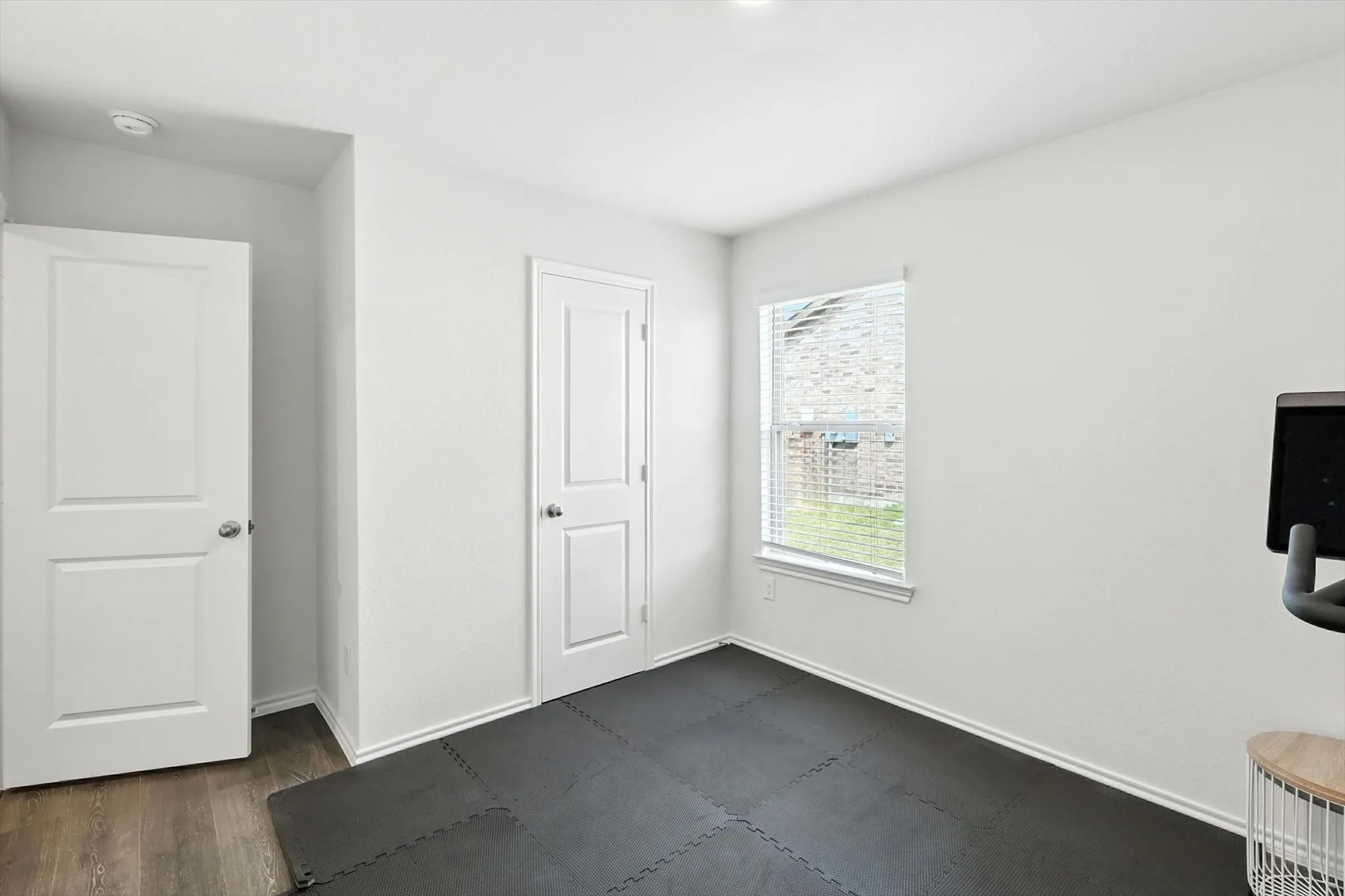 Recessed lighting and a window with blinds provide illumination