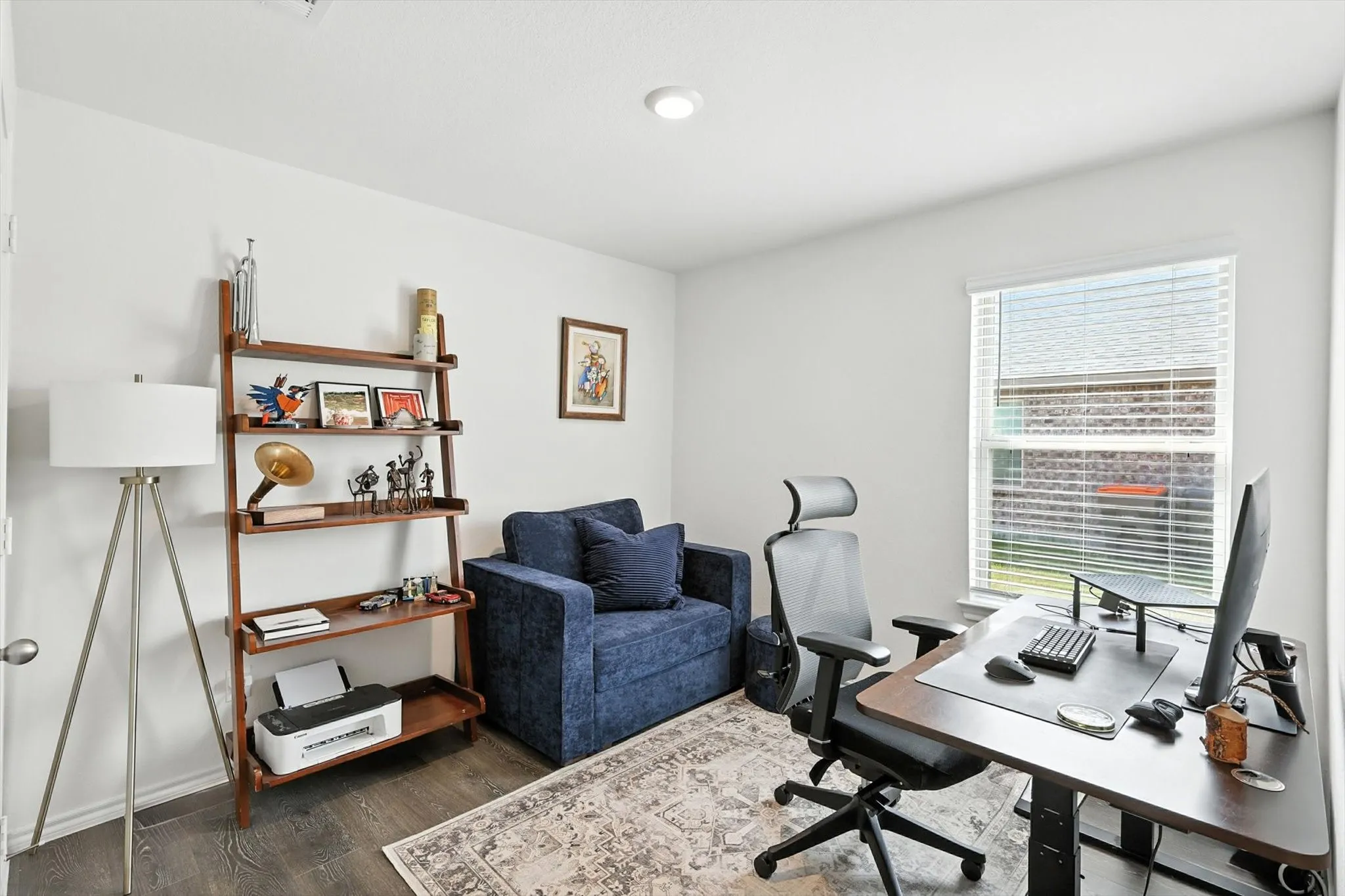 Neutral wall color, recessed ceiling lighting, wood-finish flooring, and a window with blinds