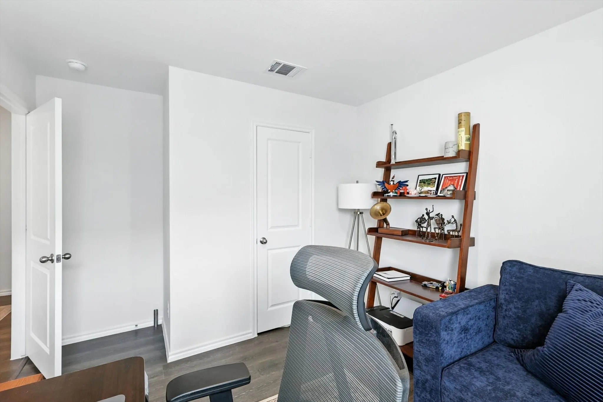 Wood-finish flooring, white paneled doors, and neutral wall tones
