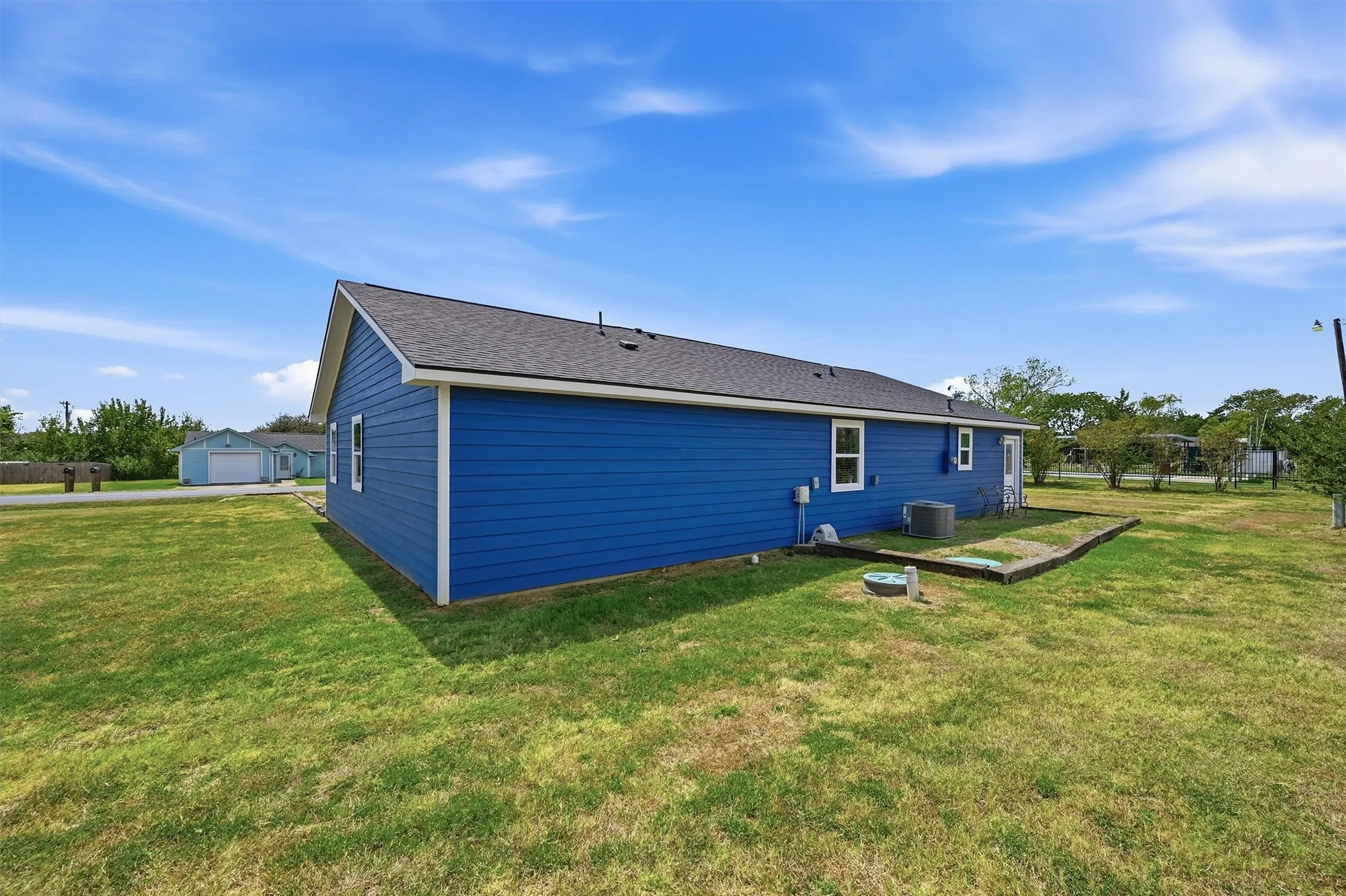 Siding exterior with multiple windows and a gray shingle roof