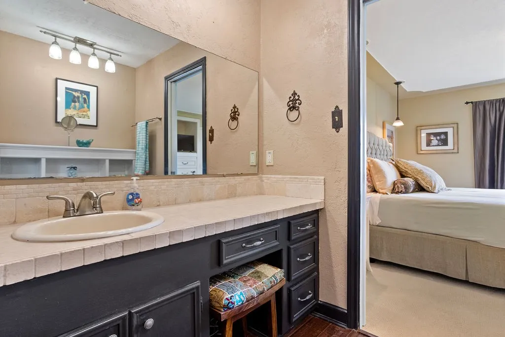 Primary bath adjacent, area across from sink is large enough for a dresser