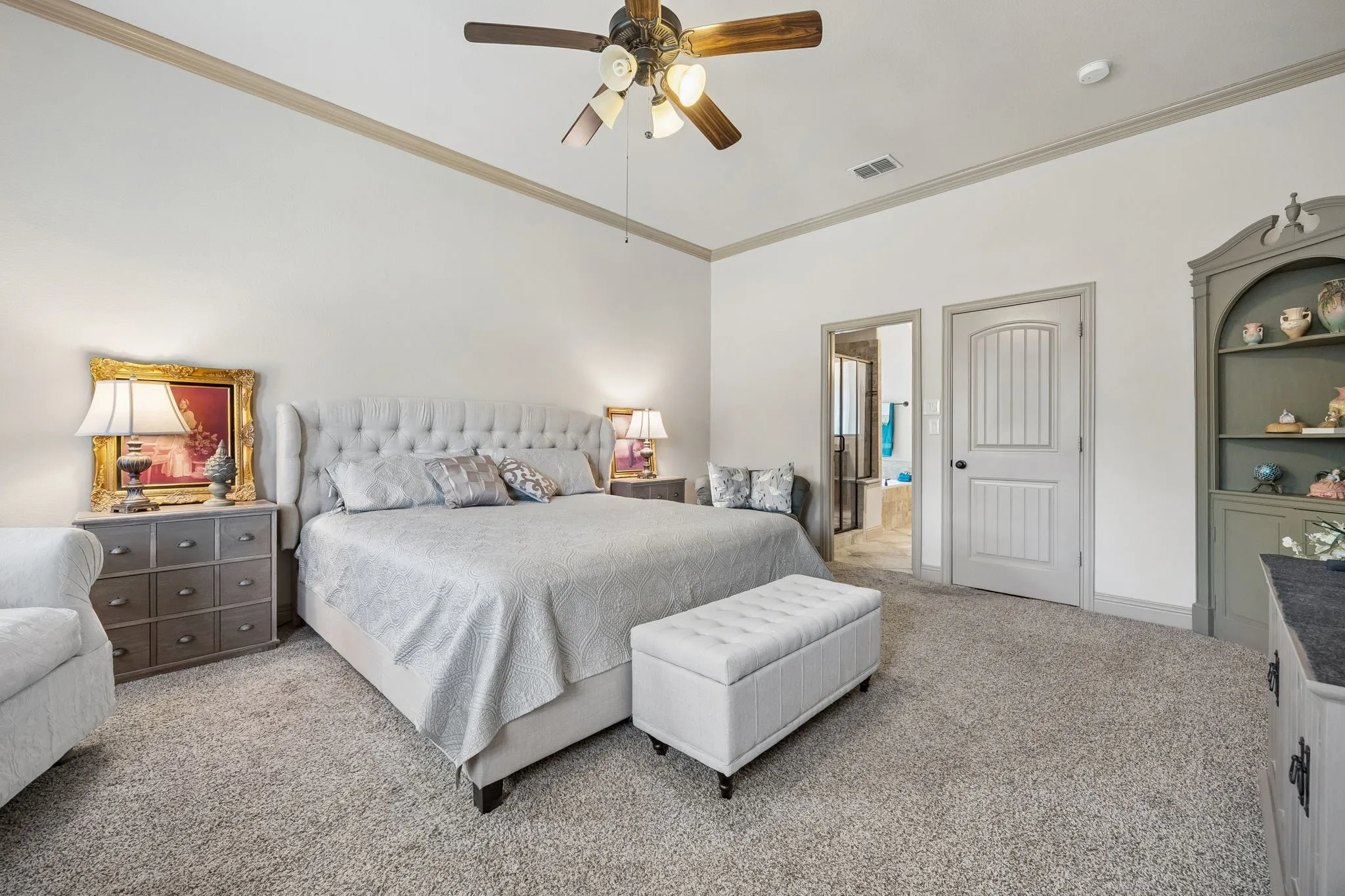 Spacious room featuring carpeting, crown molding, and a ceiling fan