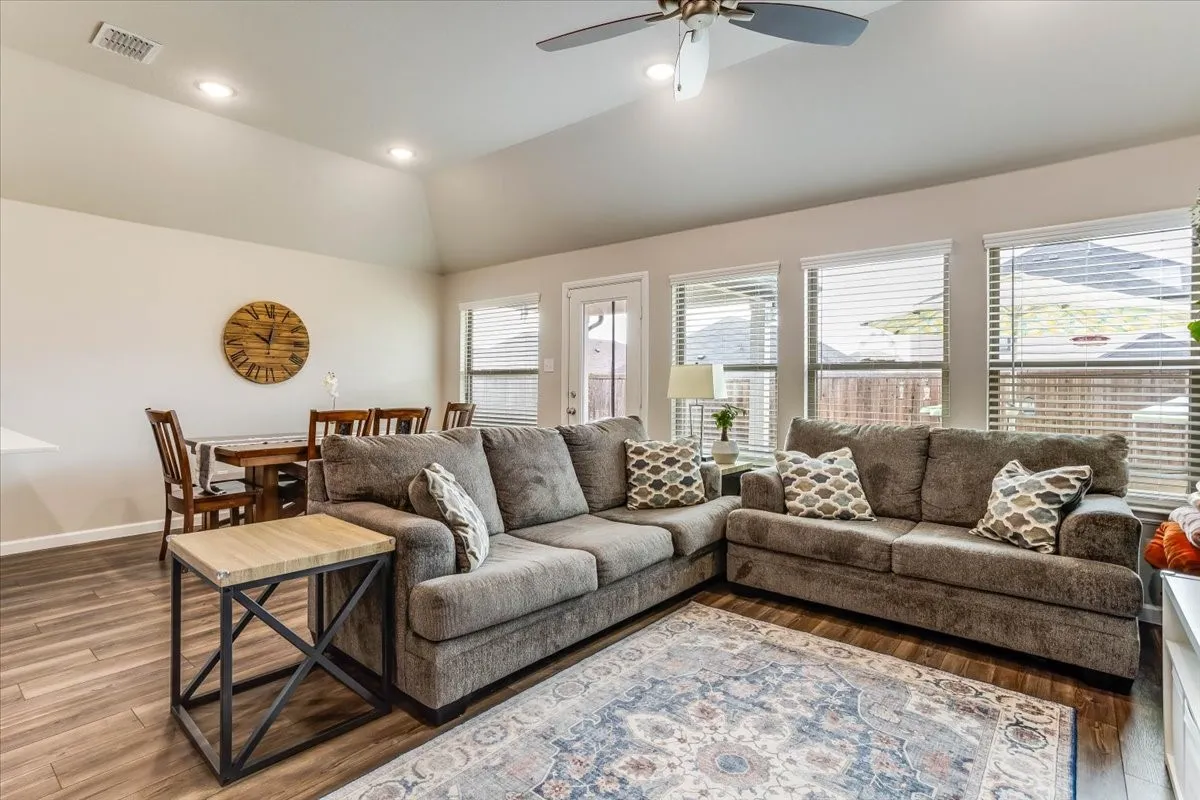 Vaulted ceiling with recessed lighting and a ceiling fan