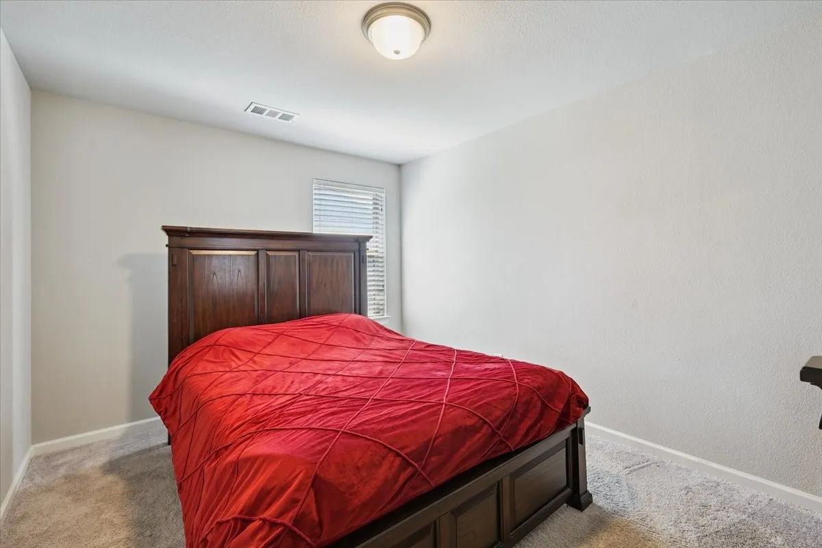 Bedroom with light colored carpet