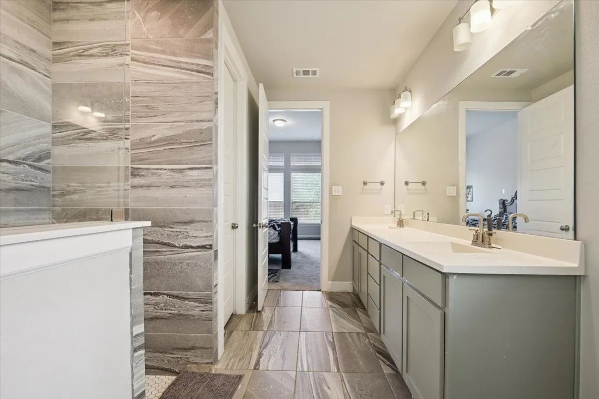 Ensuite bathroom with double vanity and a walk in shower