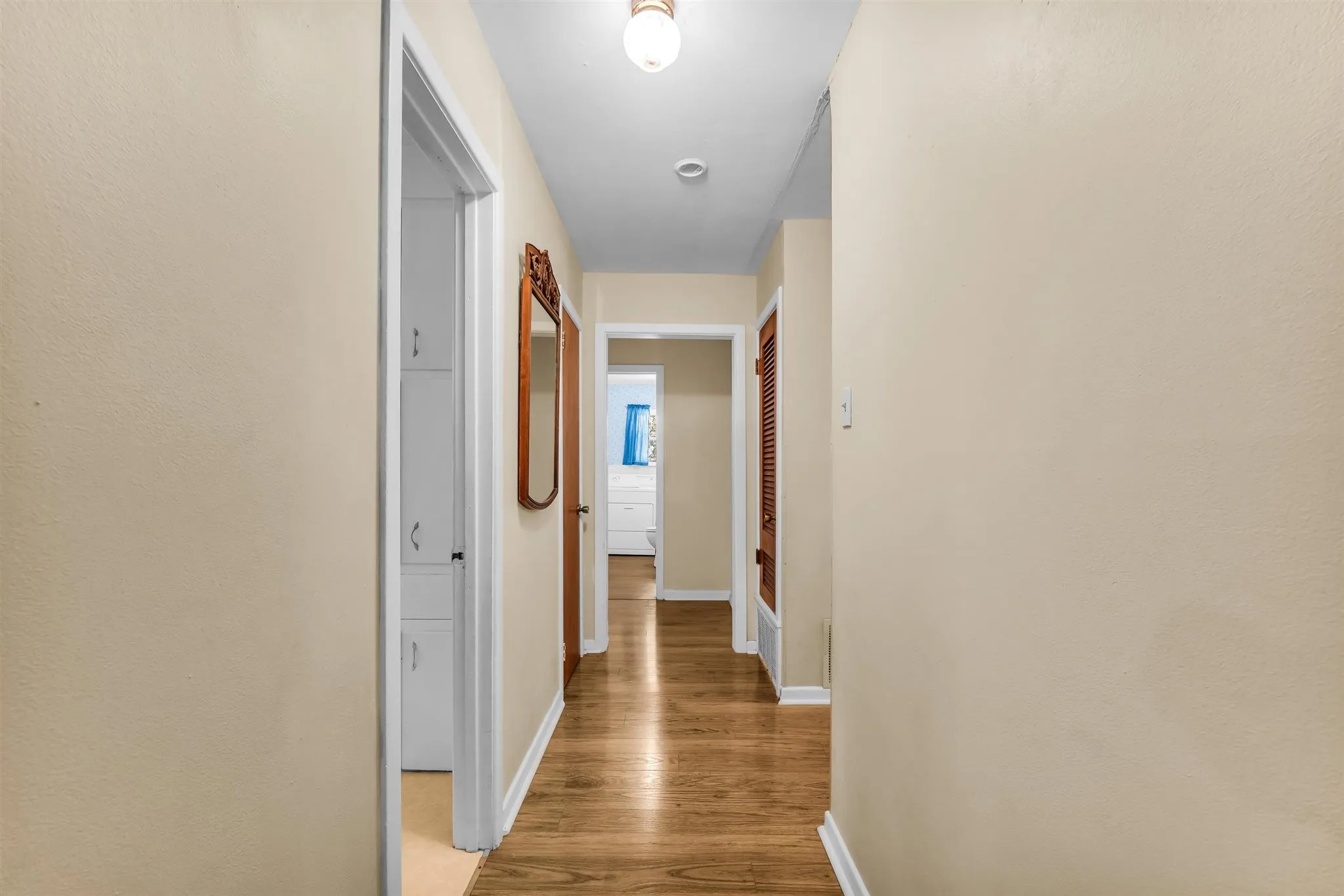 Wood-finish flooring throughout the hallway