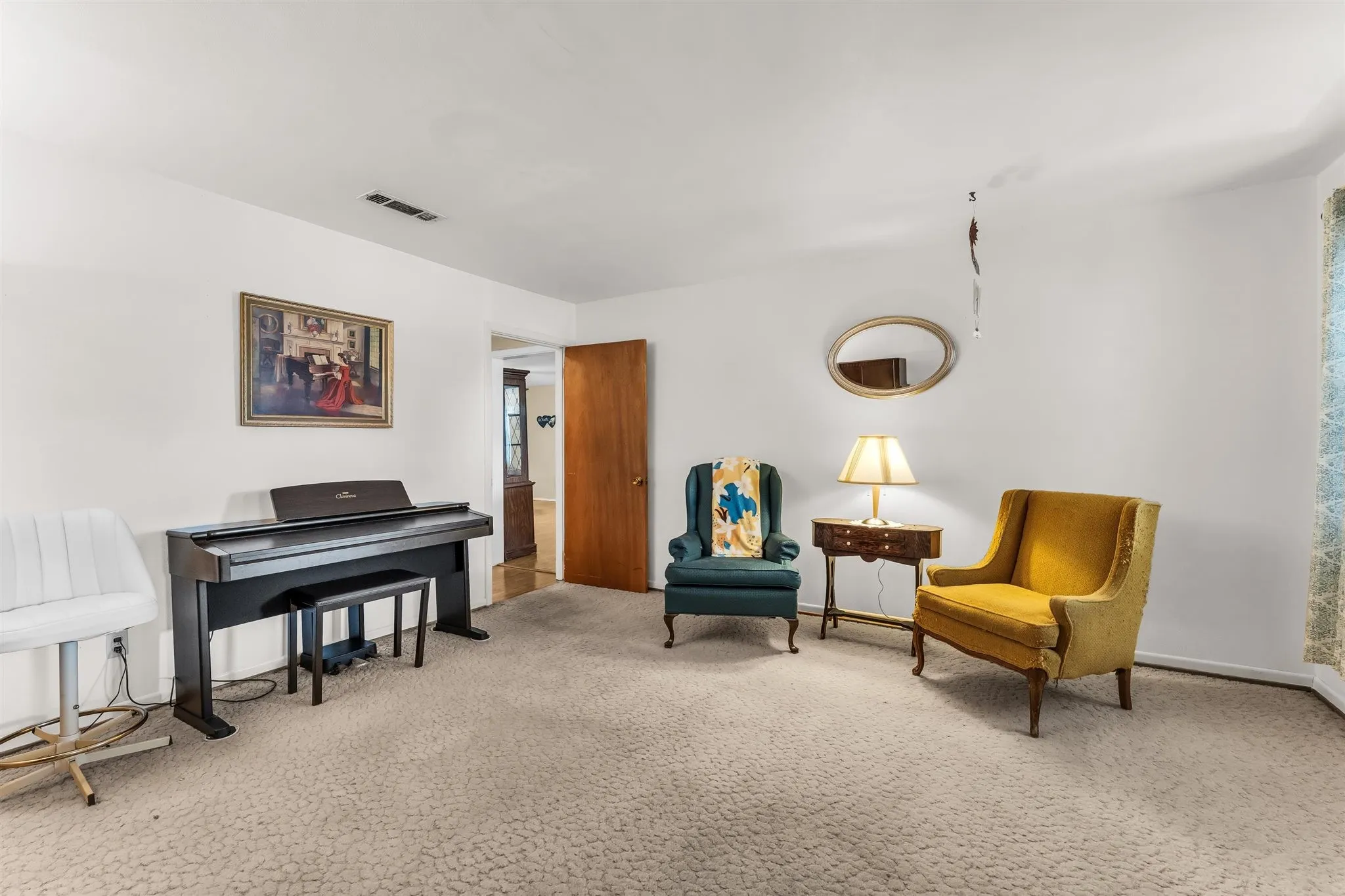 Carpeted flooring, white wall finishes, and a wood-finish interior door
