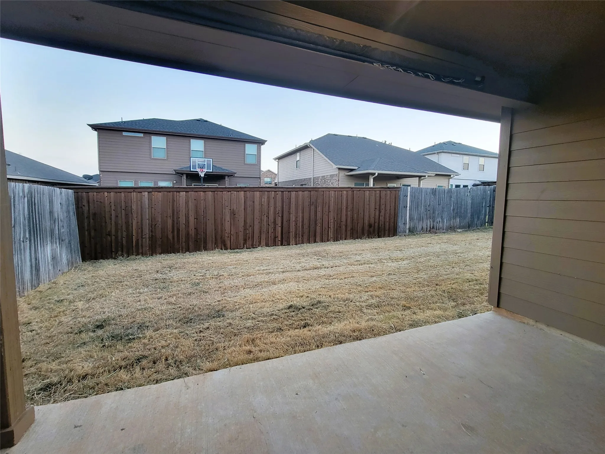 Expansive fenced backyard with a concrete patio
