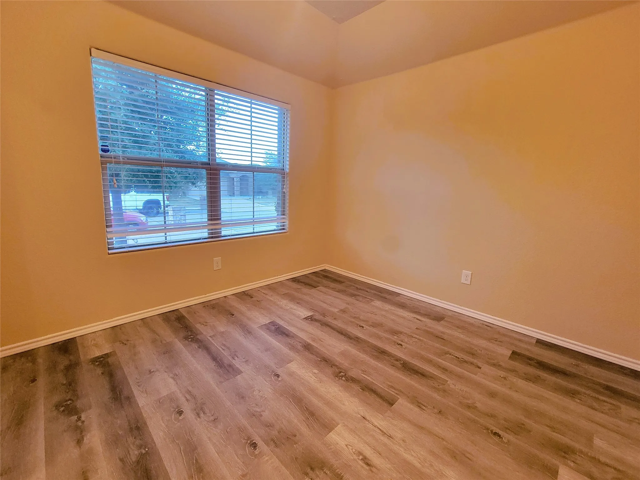 Vinyl Plank Wood-finish flooring with neutral wall paint and white trim