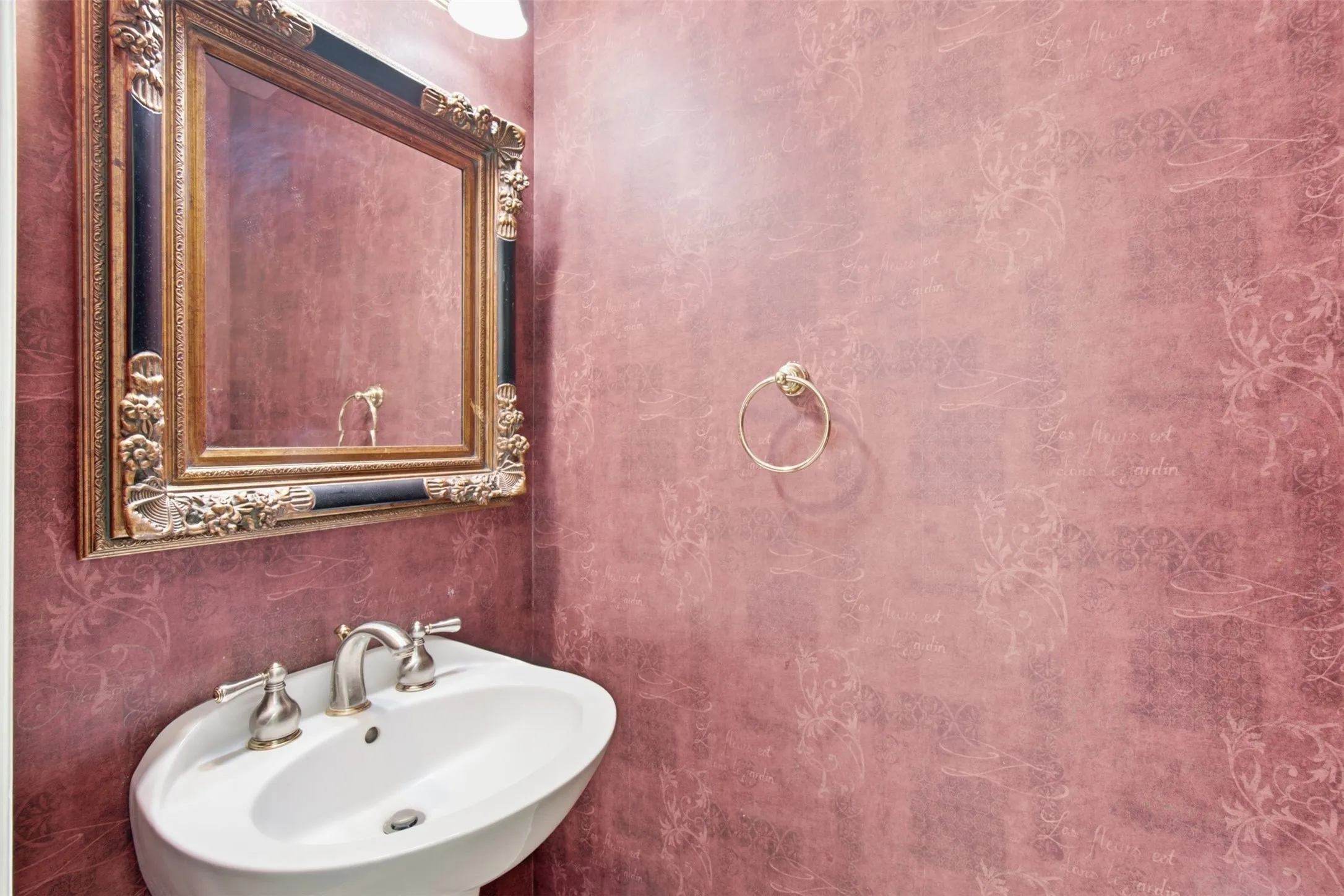 This conveniently located half bathroom on the main level serves as a perfect, accessible amenity for visiting guests while ensuring privacy remains intact in the primary living areas.