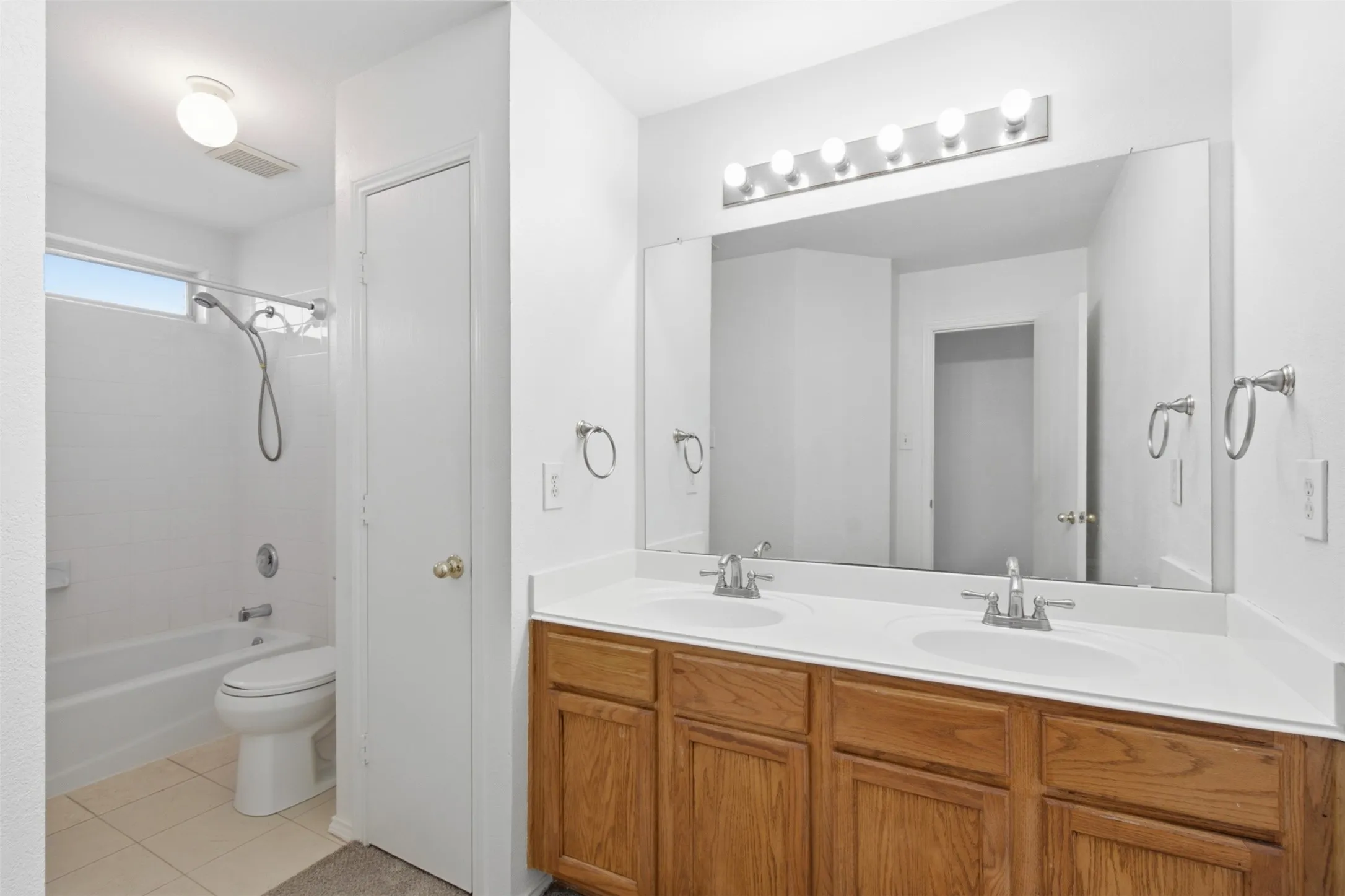 This primary bathroom features double sink and ample storage