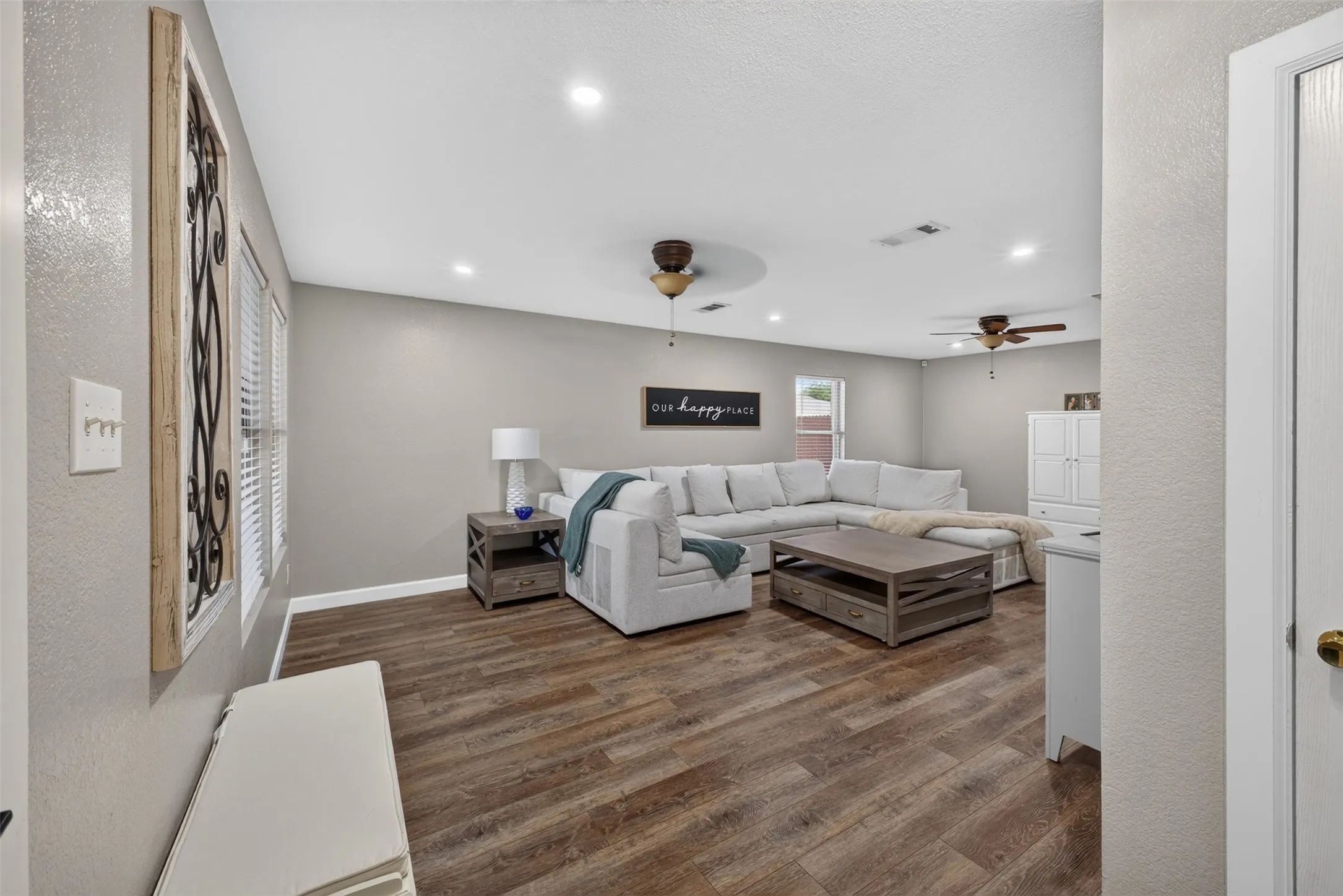 Wood-finish flooring throughout, recessed lighting, and ceiling fans
