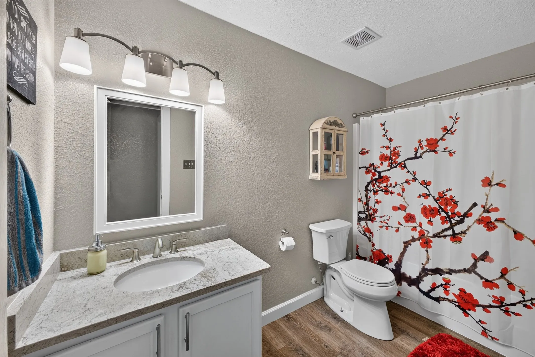 Vanity with a light-colored countertop, undermount sink, and chrome faucet