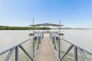 Private boat dock with covered slips and metal railings