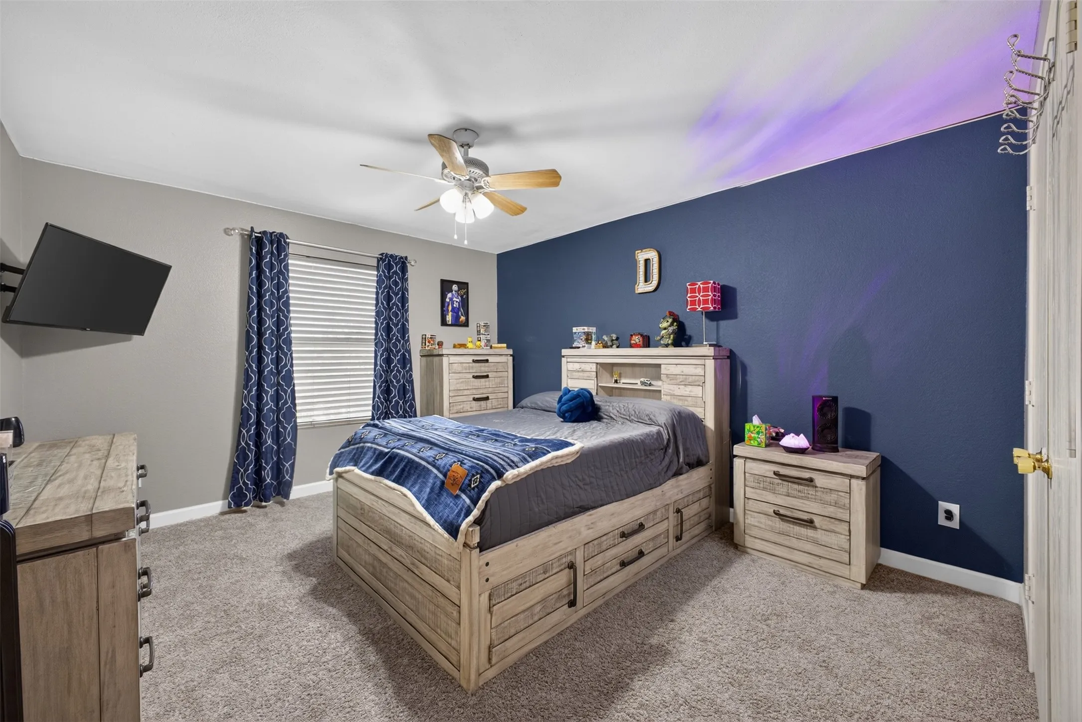 Plush carpeting, ceiling fan with integrated lighting, window with blinds, and painted walls