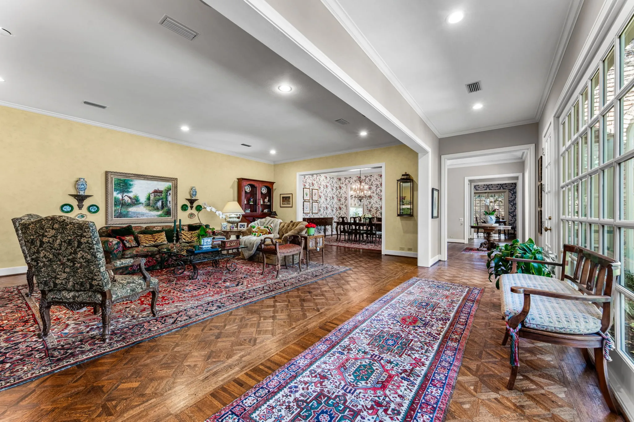 Parquet wood flooring, recessed lighting, and crown molding