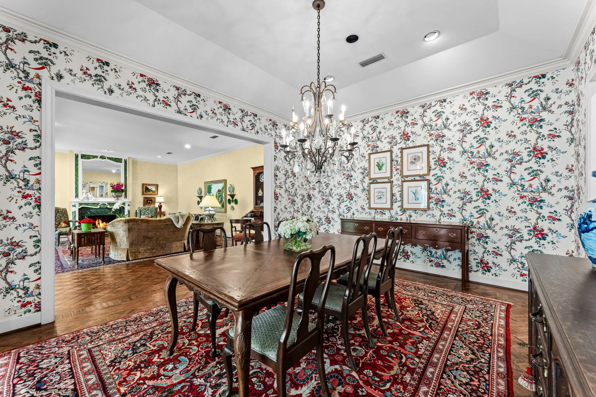 Hardwood flooring, decorative chandelier, recessed lighting, crown molding, and a wide cased opening