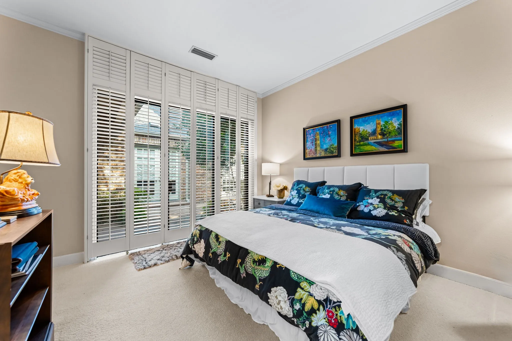 Wall-to-wall carpeting with crown molding and neutral wall tones
