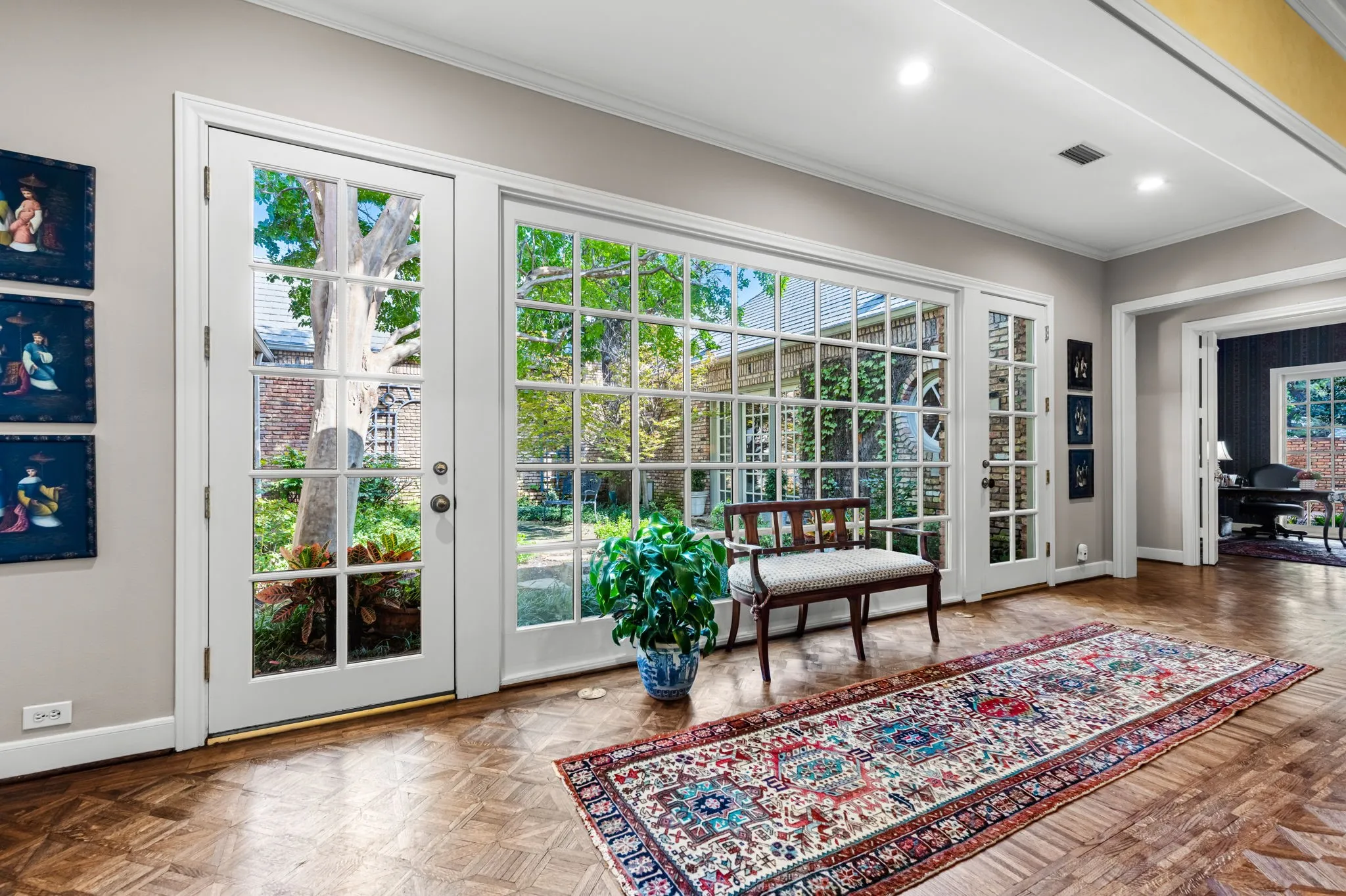 French doors and expansive grid-pattern windows, recessed lighting, and parquet wood-finish flooring