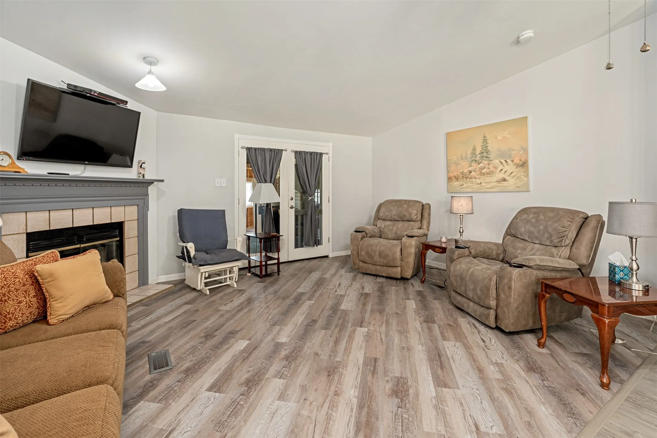 Living room with wood burning fireplace.