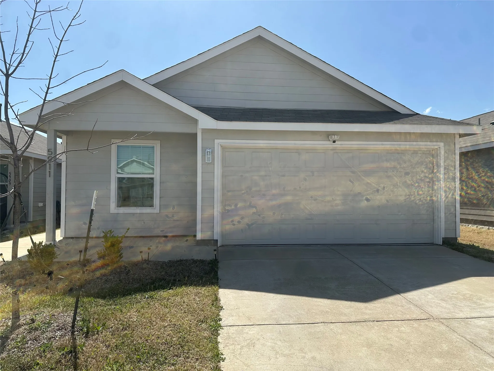 View of front of house featuring driveway and an attached garage