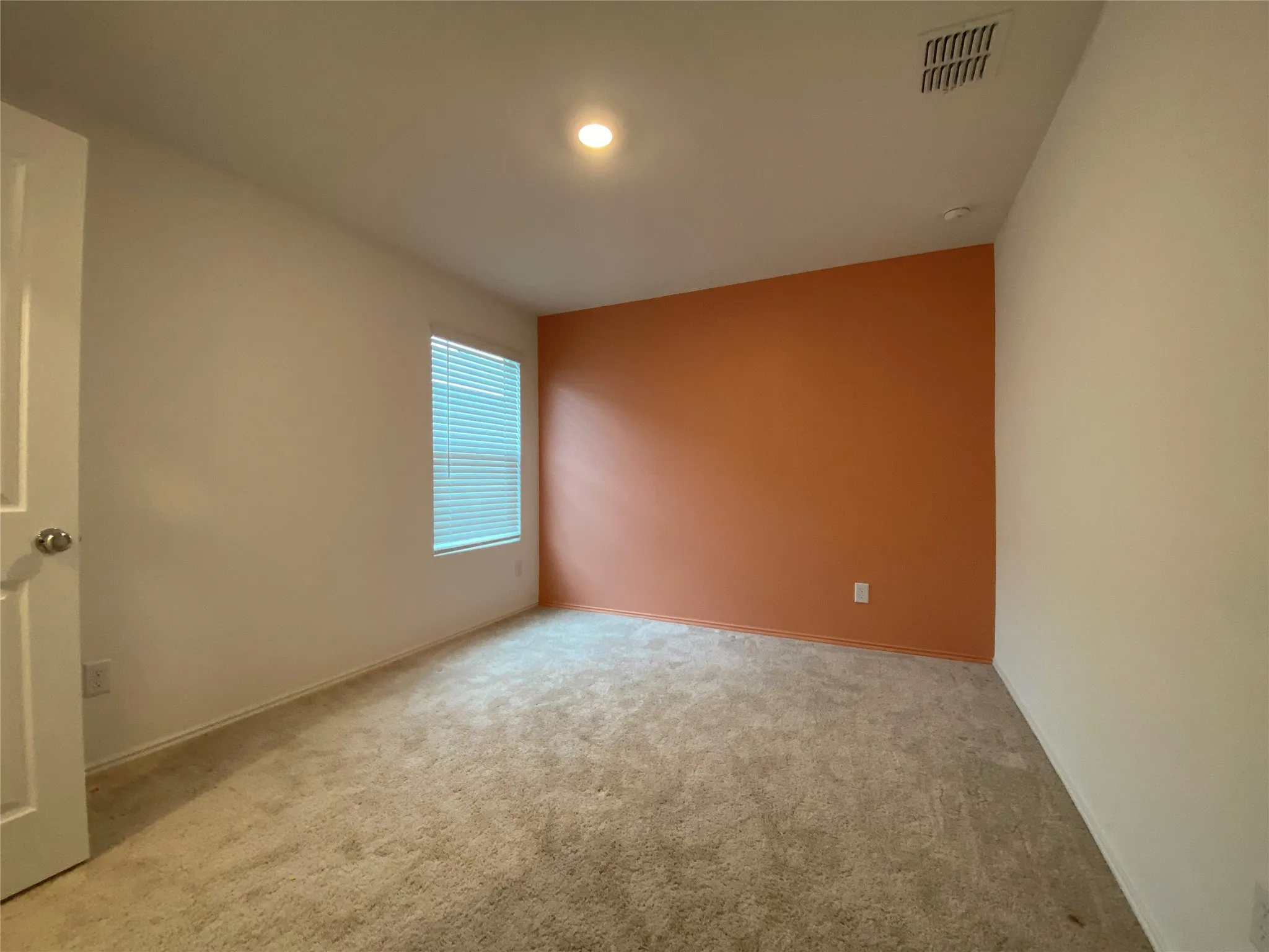 Spare room featuring baseboards, carpet flooring, and visible vents