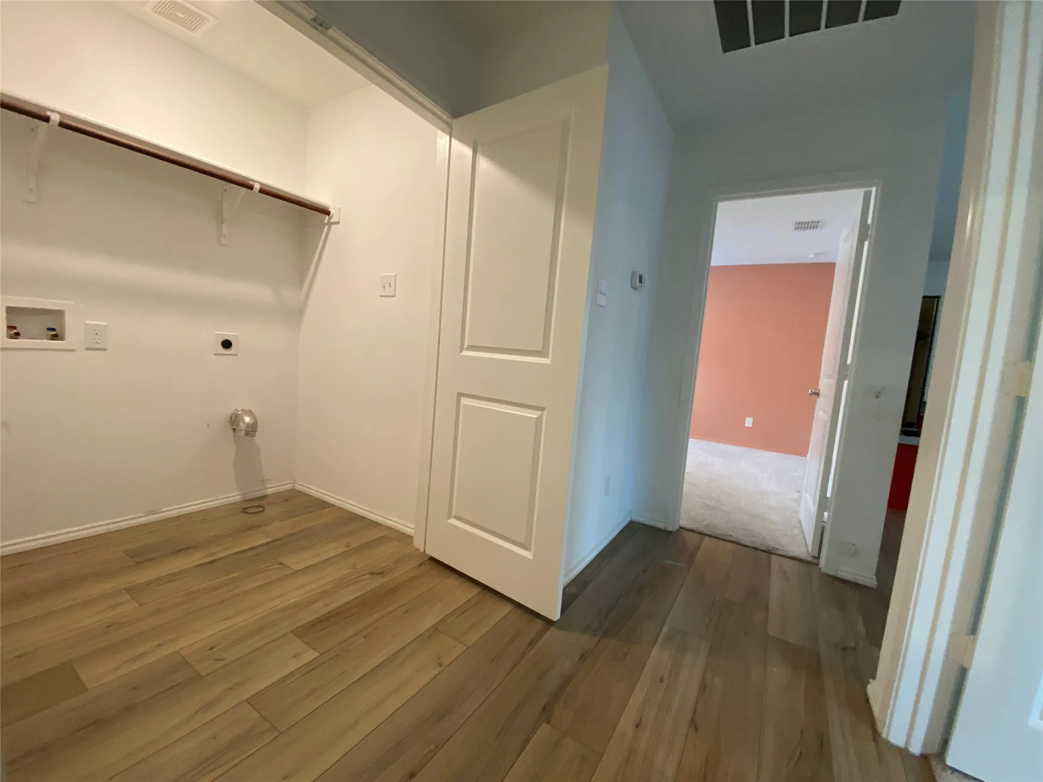 Clothes washing area featuring visible vents, laundry area, hookup for a washing machine, and electric dryer hookup
