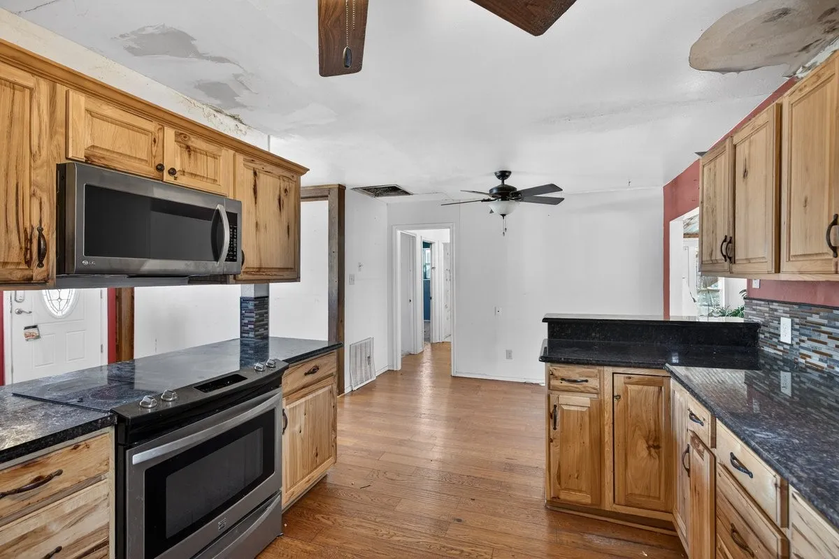 Kitchen has granite countertops, updated cabinets and appliances.