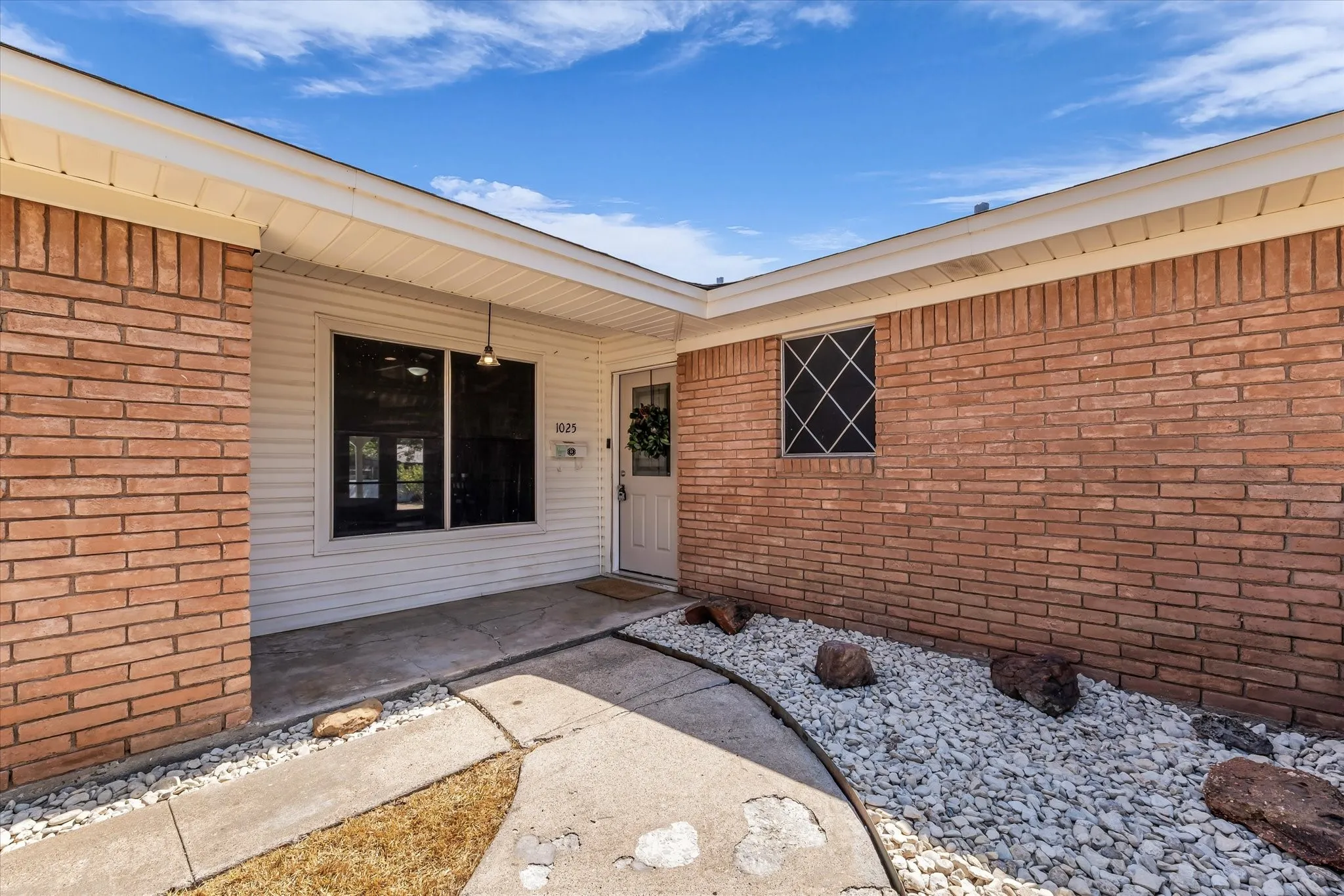 Red brick exterior with white siding accents