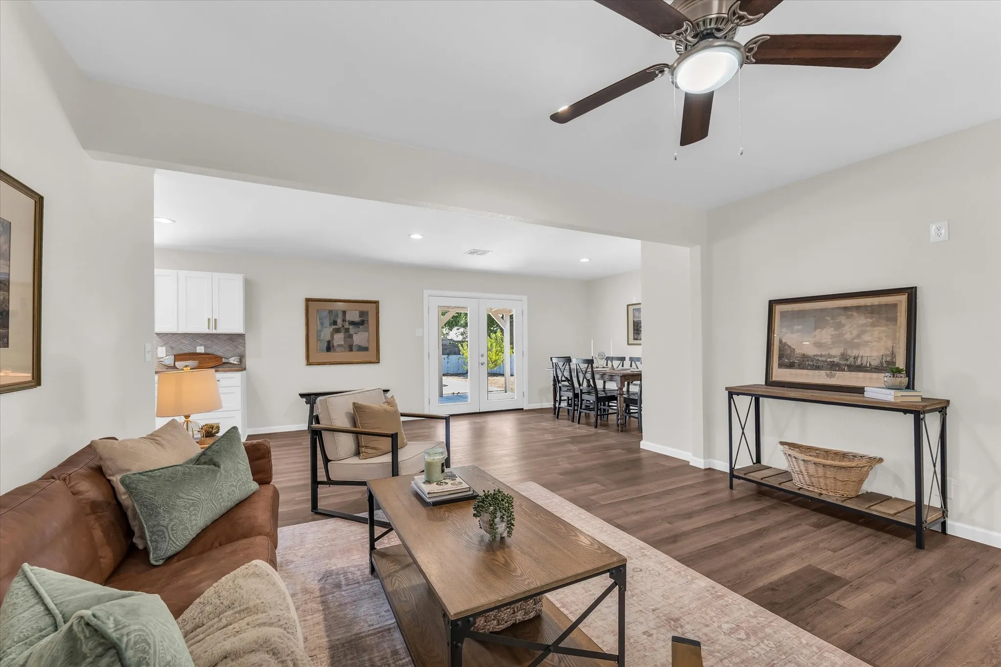 Recessed lighting with a ceiling fan, wood-finish flooring, white wall paint, and white trim
