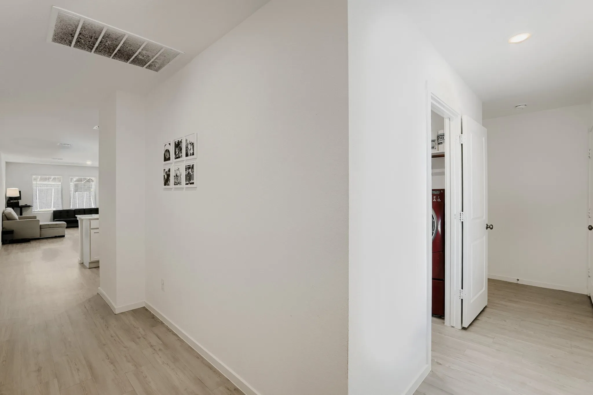 Light wood-finish flooring extends through the hallway
