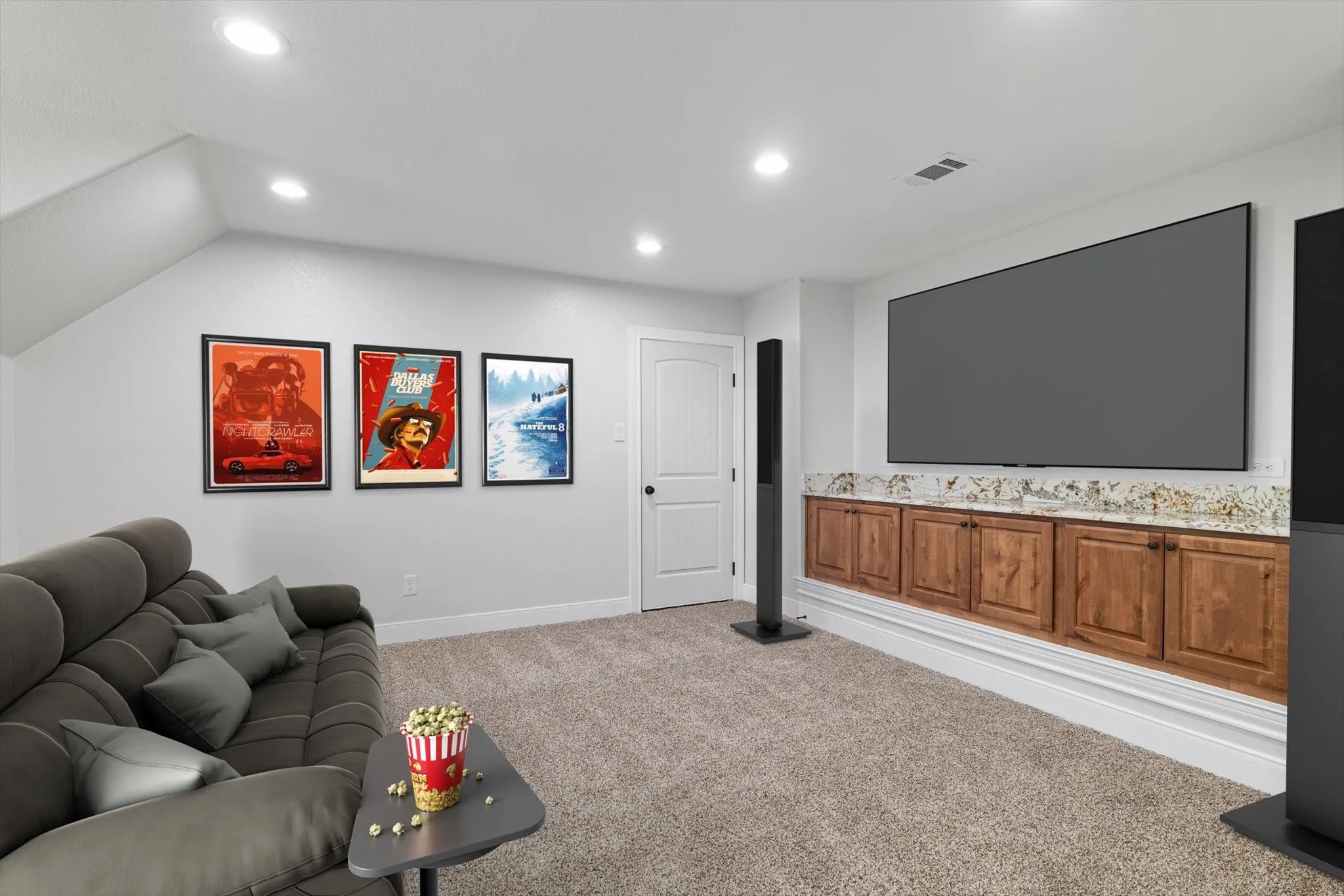 Spacious room featuring recessed lighting, a large built-in media console with wood cabinetry, and a stone countertop